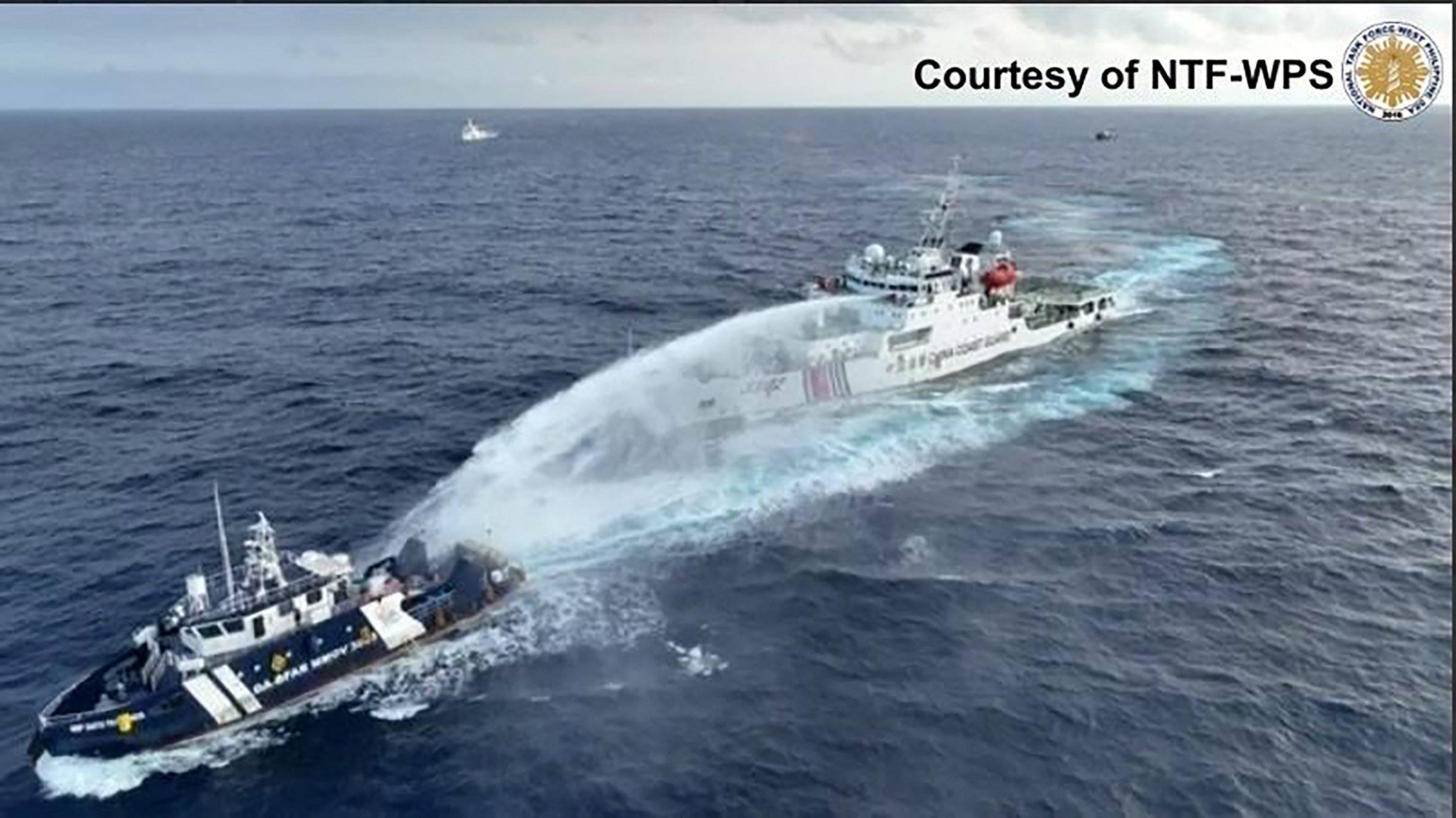 A China Coast Guard ship (right) deploys water cannon at a Phillipine Bureau of Fisheries and Aquatic Resources vessel BRP. Photo: National Task Force for the West Philippine Sea/AFP